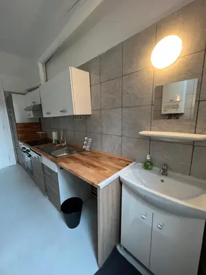a small kitchen with a sink and a counter top at Proche de tout lieux touristiques à Liège in Liège