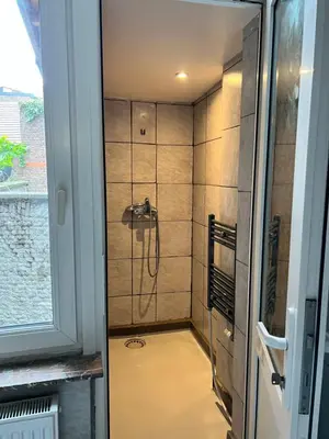 a shower with a shower head in a bathroom at Proche de tout lieux touristiques à Liège in Liège