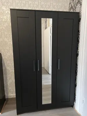 a black wardrobe with a mirror in a room at Proche de tout lieux touristiques à Liège in Liège