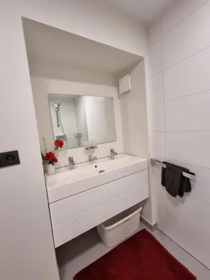 a white bathroom with a sink and a mirror at Susberg 3 in Pelt