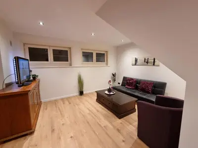 a living room with a couch and a tv at Susberg 3 in Pelt