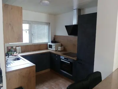 a small kitchen with a sink and a microwave at Agréable maison avec cour à 10min de Liège in Herstal
