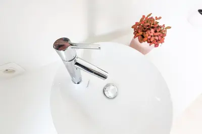 a sink with a faucet in a bathroom at Huis van Hout - architectenwoning met grote panorama tuin - design hot tub optioneel in Herk-de-Stad