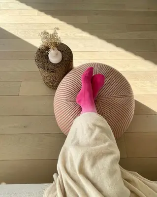 a person laying on a table with a pink umbrella at Huis van Hout - architectenwoning met grote panorama tuin - design hot tub optioneel in Herk-de-Stad