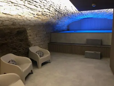a room with two chairs and a swimming pool at Gîte Jaja in Limbourg