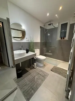 a bathroom with a sink and a toilet and a shower at Le Makalle in Dalhem