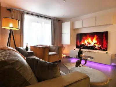 a living room with a couch and a fireplace at SuiteDreams - Relax Suite Liège in Liège