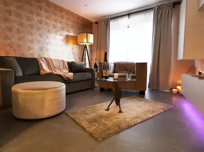 a living room with a couch and a table at SuiteDreams - Relax Suite Liège in Liège