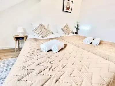 two beds with towels on top of them in a bedroom at Logies by Suzan in Hasselt