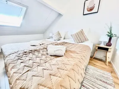 a bedroom with a large bed in a attic at Logies by Suzan in Hasselt