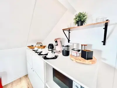 a kitchen with a counter with a stove top oven at Logies by Suzan in Hasselt