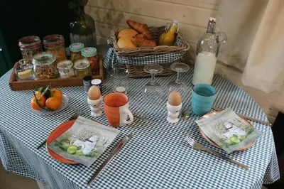a table with eggs and a basket of food on it at Pia B&B Babbita in Hasselt