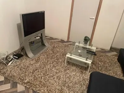 a living room with a flat screen tv sitting on a pile of hay at Belle appartement sur liège in Liège