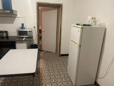 a small kitchen with a refrigerator and a microwave at Belle appartement sur liège in Liège