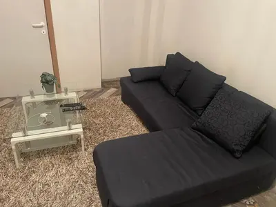 a living room with a couch and a table at Belle appartement sur liège in Liège