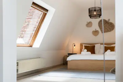 a bedroom with a bed and a window at Saint Pablo Boutique Apt I 3BR, Grote Markt, City Center, Near Station in Hasselt