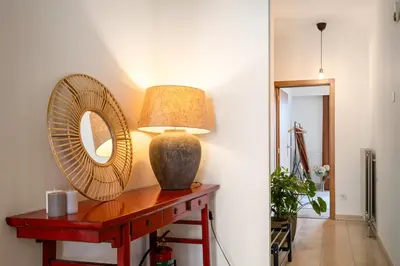 a table with a mirror and a lamp on it at Saint Pablo Boutique Apt I 3BR, Grote Markt, City Center, Near Station in Hasselt