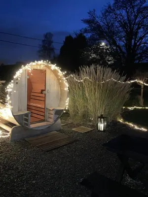 a small observatory with lights in a yard at night at Cour 44 - Gite de charme avec sauna et jacuzzi in Remicourt