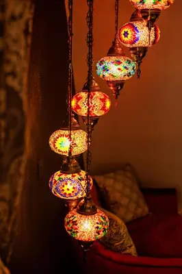 a chandelier with colorful lights hanging from a wall at B&B 1001 nacht in Zonhoven