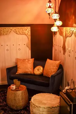 a living room with a couch and a table at B&B 1001 nacht in Zonhoven