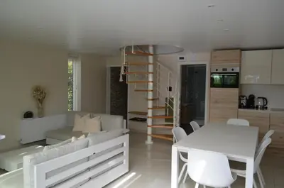 a white living room with a white table and chairs at Holiday Home Mooi-Gemmenich in Plombières
