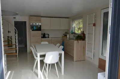 a kitchen with a white table and white chairs at Holiday Home Mooi-Gemmenich in Plombières