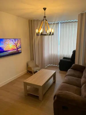 a living room with a couch and a coffee table at R&M in Kortessem