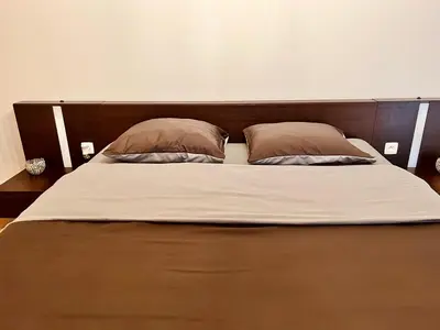 a large bed with two pillows on top of it at R&M in Kortessem