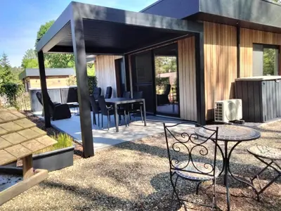 a backyard patio with a table and chairs at Theressa - Free Wifi en Netflix in Zutendaal