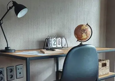 a desk with a blue chair and a desk with a globe on it at Vakantiewoning - ‘t Ouwershuys in Opoeteren