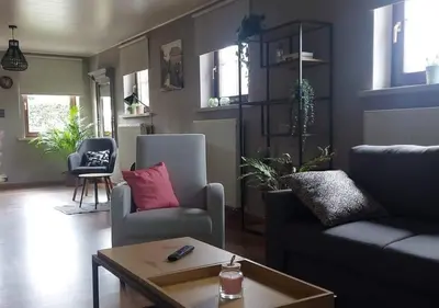 a living room with a couch and a table at Vakantiewoning - ‘t Ouwershuys in Opoeteren