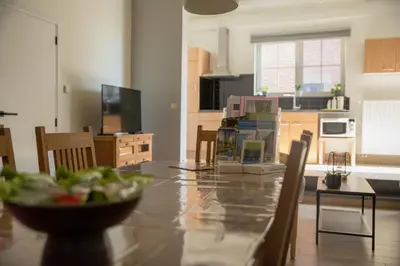 a kitchen and dining room with a table and chairs at Vakantiewoningen Pomona in Heers