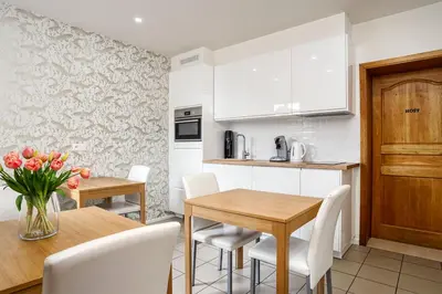 a kitchen and dining room with a table and chairs at BnB Pastel -B&B Breakfast Included- in Dilsen-Stokkem