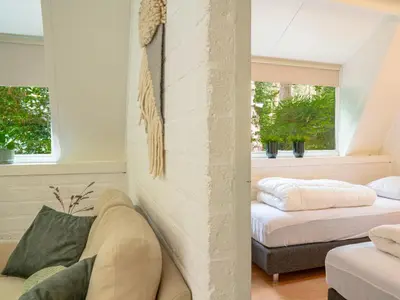 a living room with two beds and a couch at Boshuisje Rekem - Boris in Lanaken