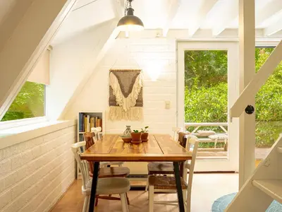 a dining room with a table and chairs at Boshuisje Rekem - Boris in Lanaken