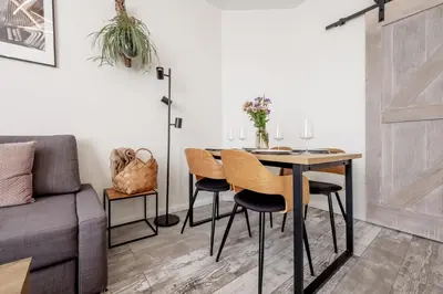 a dining room with a table and chairs and a couch at Marshmallow in Liège