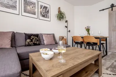 a living room with a couch and a wooden table at Marshmallow in Liège