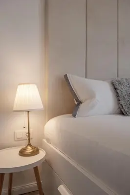 a bed with a lamp on a side table at Marshmallow in Liège