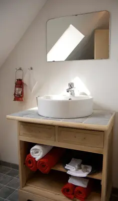 a bathroom vanity with a sink and a mirror at B&B La ferme de Berwausault in Herve
