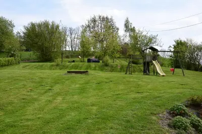 a yard with a playground with a slide at B&B La ferme de Berwausault in Herve