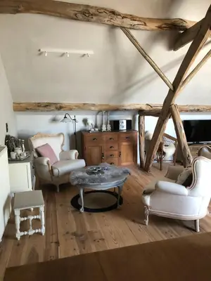 a living room with a table and two chairs at Welness gastenverblijf Carpe Diem in Oudsbergen