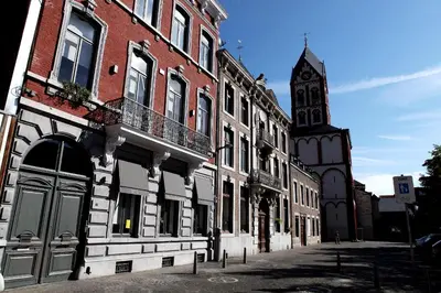 a building with a clock tower on a street at B&B N°5 in Liège