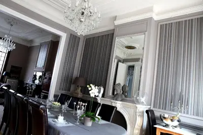 a dining room with a table and a mirror at B&B N°5 in Liège