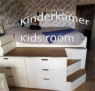 a bed with white drawers and a kids room at Bed & Bokes aan de Maaskant in Lanaken