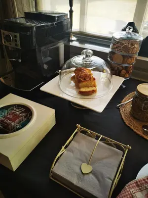 a table with a plate of cake and a spoon at Bed & Bokes aan de Maaskant in Lanaken