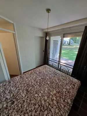a bedroom with a bed with rocks on it at Gezellig appartement in groene omgeving in Drijhoeven