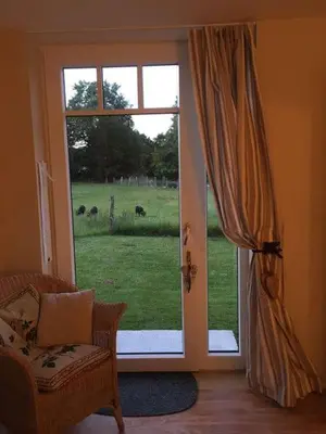 an open door with a view of a field at Haus Dany in Raeren