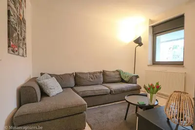 a living room with a couch and a table at De Millenniumhoeve (Willy) in Riemst