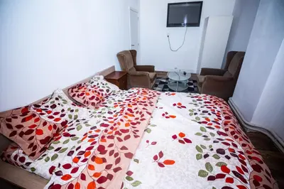 a bedroom with a bed with a floral comforter at Belle chambre sur liège in Liège