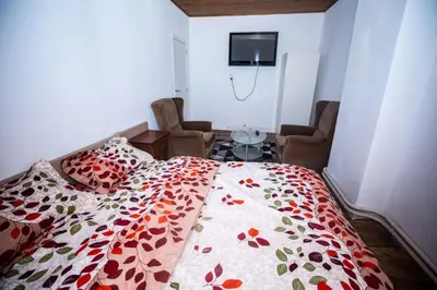 a bedroom with a bed with a colorful comforter at Belle chambre sur liège in Liège